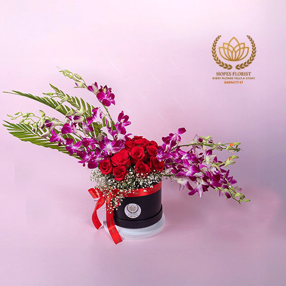Pretty rose & orchid arrangement