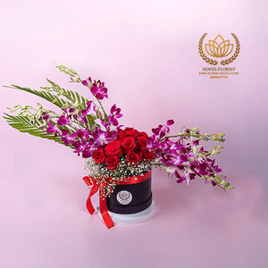 Pretty rose & orchid arrangement